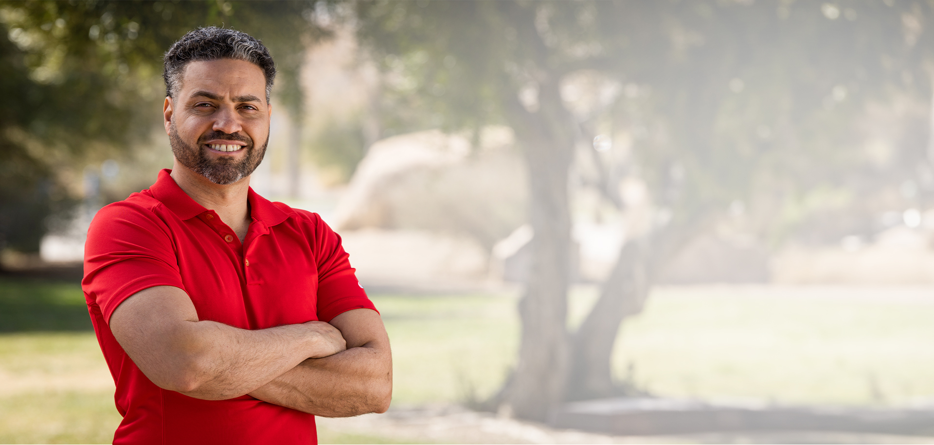 Rafael Arroyo smiling with his arms crossed