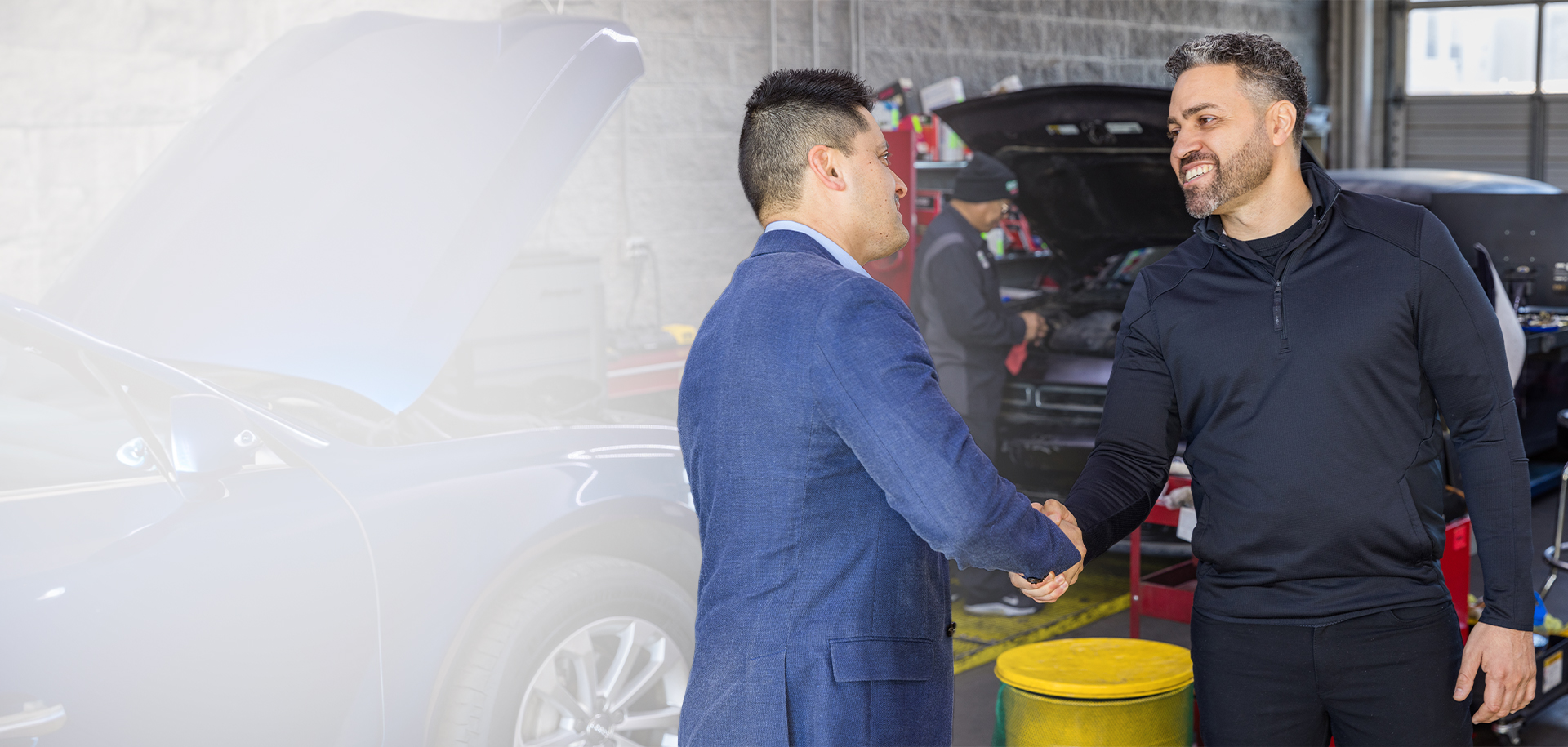 Rafael Arroyo shaking hands with small business owner